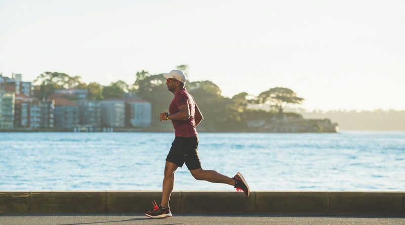 man running near sea during daytime