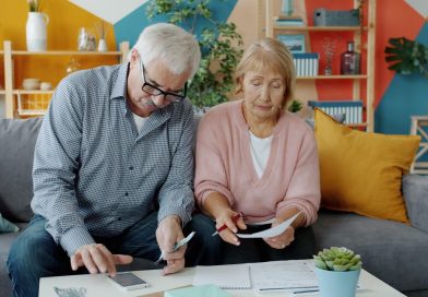 Elderly couple reviewing documents at home